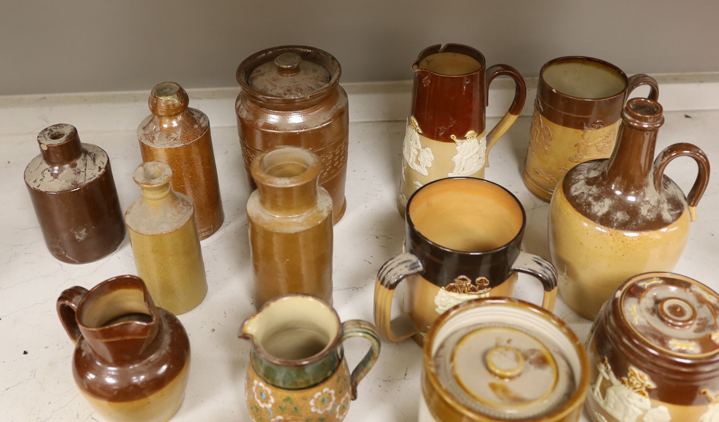 A quantity of Doulton stonewares including inkstand, jug, miniature salts and 19th century saltglaze pottery bottles, tallest item large jug 18 cms high.